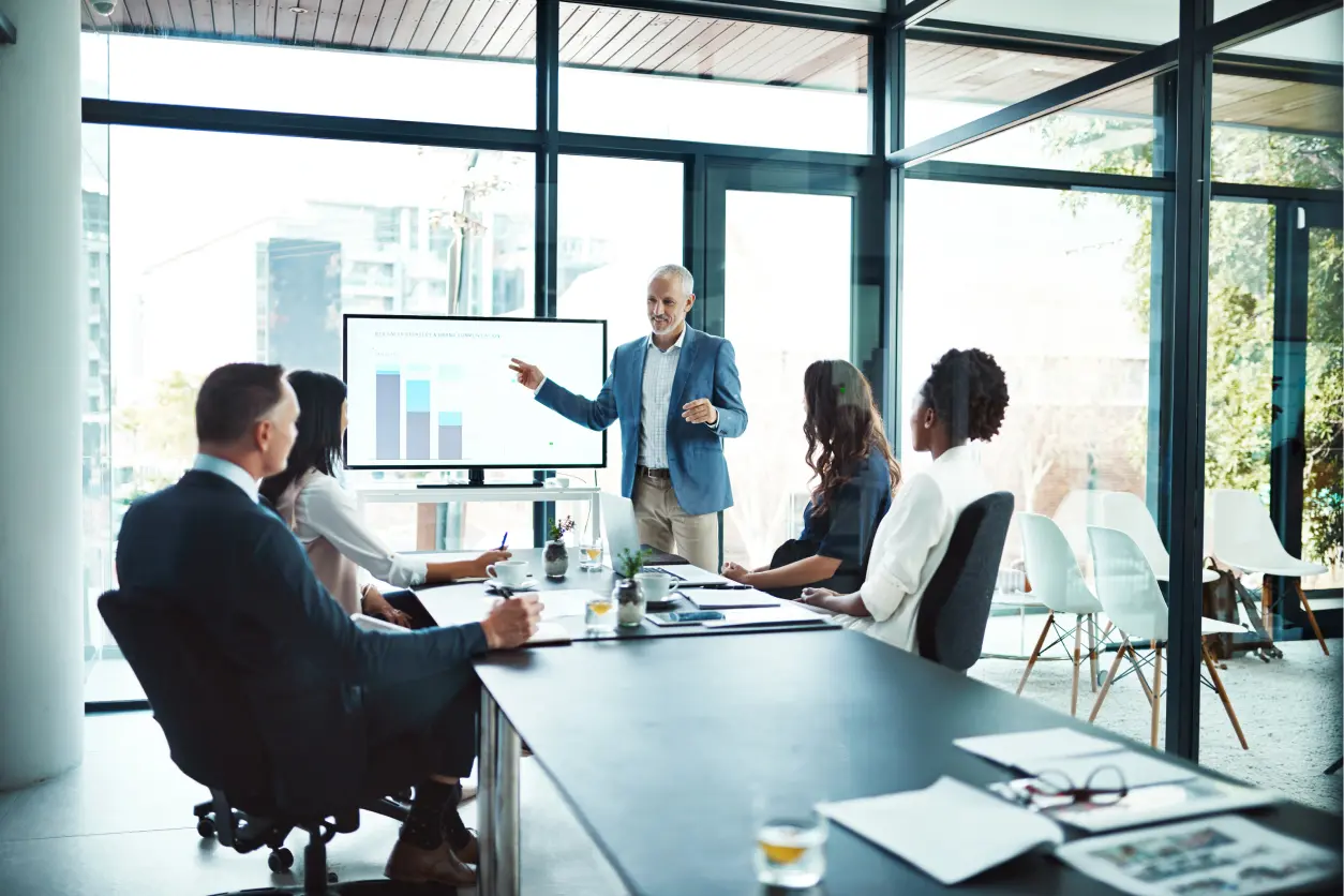 Business presentation with diverse team in office.