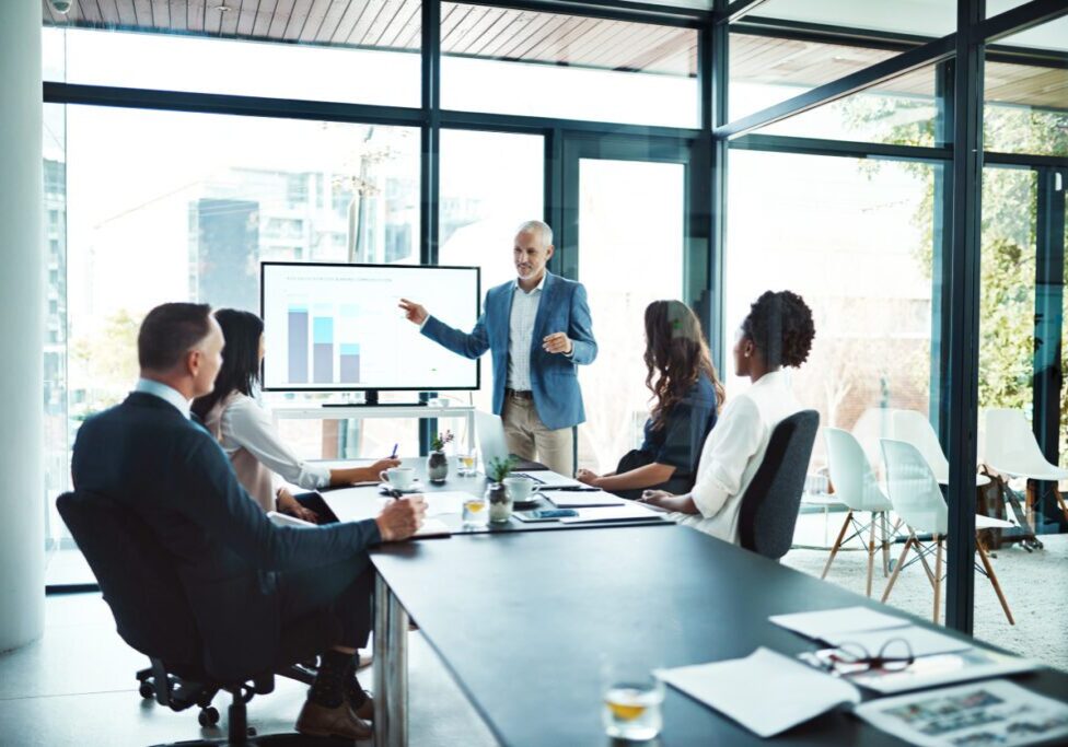 Business presentation with diverse team in office.